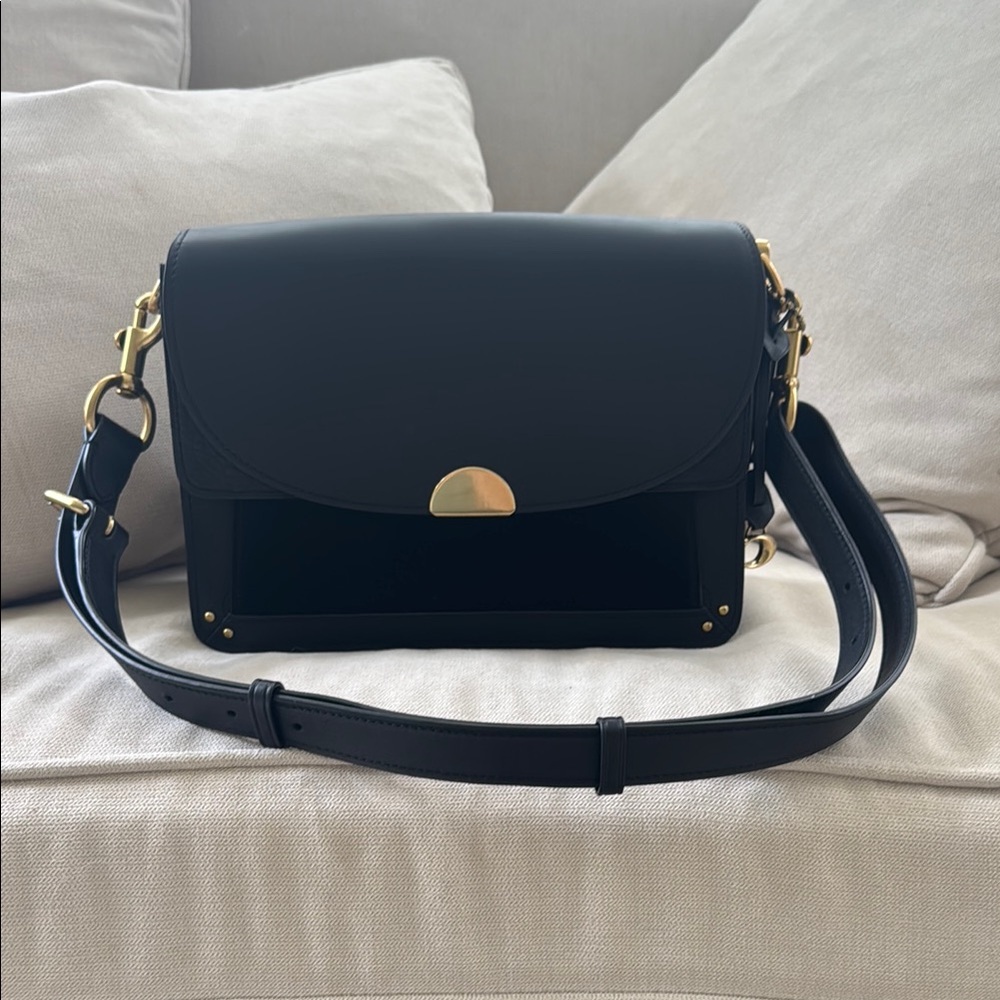 Coach Dreamer bag in black leather with gold hardware.
